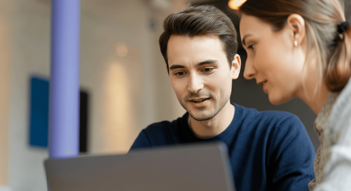 2 people looking at laptop